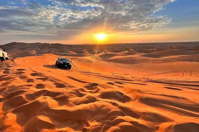 4x4 jeep driving over golden sand dunes during a morning desert safari in Dubai at sunrise